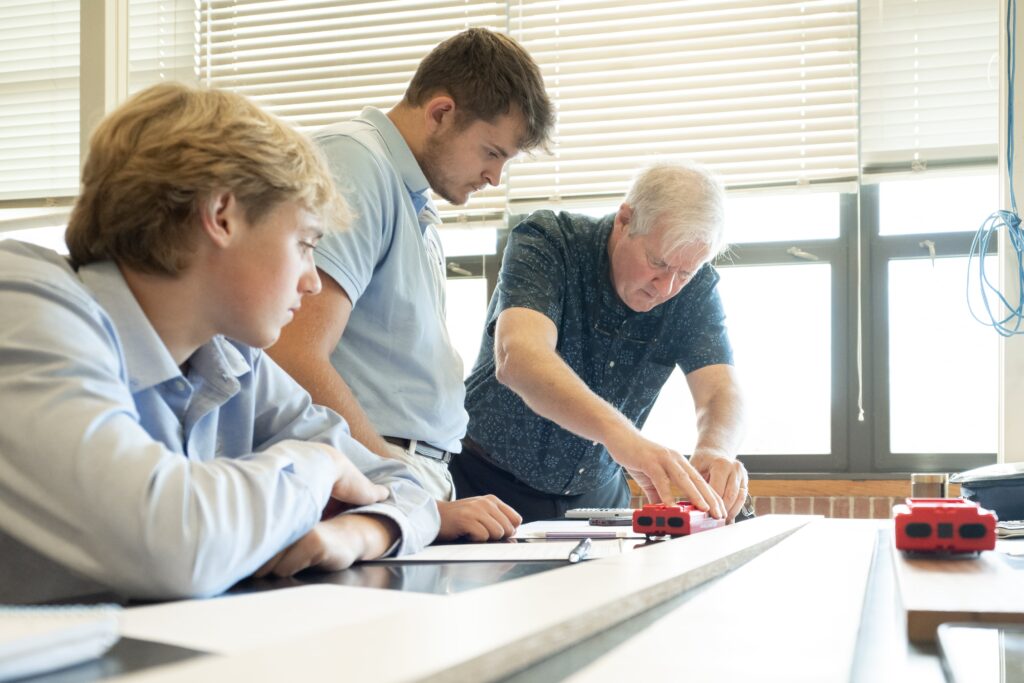 teacher and students working on project in classroom